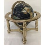 A gemstone globe in brass effect frame.