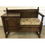 A vintage dark wood hall table with seat.