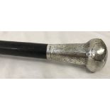 A Victorian silver topped walking cane with engraved decoration to silver work.