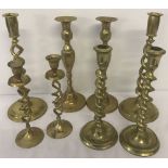 4 pairs of brass candle sticks to include 3 pairs with a barley twist style stem.