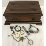 A wooden chest shaped jewellery box containing vintage watches.