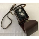 A vintage Microflex 2 lens reflex camera in leather case.