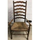 A vintage rush seated, high ladder backed carver with turned detail to front legs and arms.