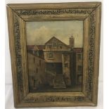 A small gilt framed oil on canvas of a town house.