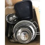 A box of vintage and new metal baking trays, flan dishes and cake tins.