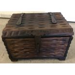 A dark wood lidded box with metal banding, catch and handles.