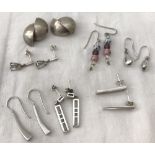 7 pairs of silver and white metal earrings.