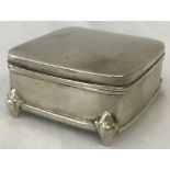 A silver 4 footed jewellery / trinket box with blue velvet lined interior and hinged lid.