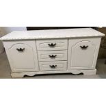 A vintage solid wood shabby chic 2 door 3 drawer low chest, painted white.