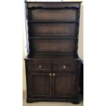 A vintage dark oak double 2 part dresser with cupboard base a shelf top.