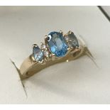 A 9ct gold Blue topaz and diamond dress ring.