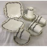 An early 20th century Shelley tea set with black border and pink roses design.