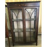A vintage 2 door glass fronted display cabinet with painted detail to front.