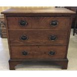 A vintage solid oak 3 drawer chest of drawers with drop down handles and shaped feet.