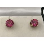 A Pair of 9ct gold and pink stone stud earrings.