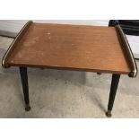 A vintage circa 1960's coffee table with screw in legs.
