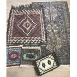 A collection of 5 assorted rugs.