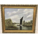 A gilt framed oil on board of a river scene with a wherry.