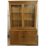 A vintage light oak double glass topped display cabinet.