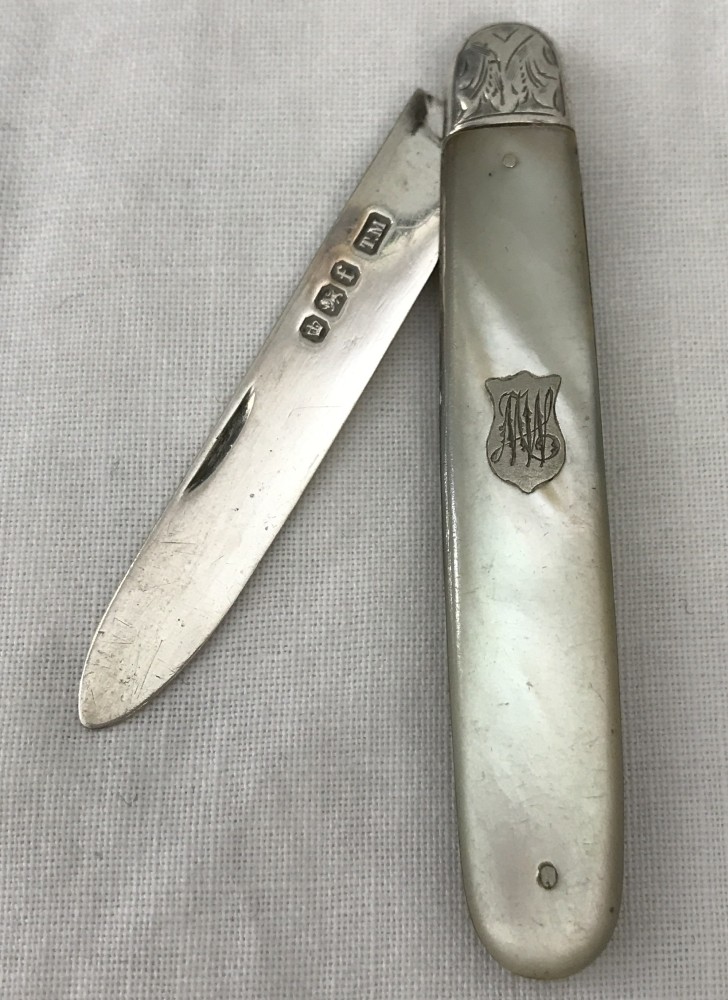 A silver fruit knife with mother of pearl handle.