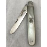 A silver fruit knife with mother of pearl handle.