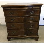 A vintage dark wood curve fronted 4 drawer chest.