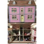 A large wooden front opening dolls house painted and fully furnished, with lift up roof.