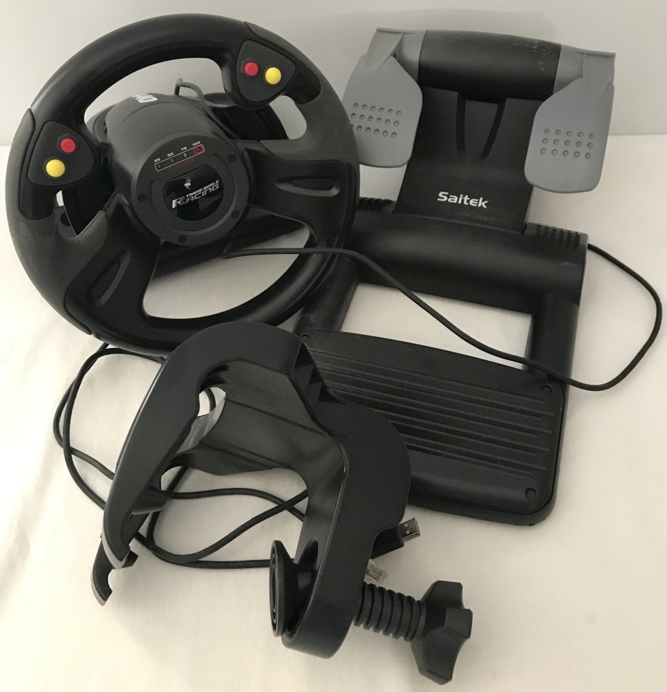 A boxed Saitek R440 Force Feedback Trans-World Racing Steering wheel control and foot pedal.