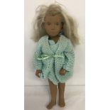A vintage Gotz Sasha doll with blonde hair and blue eyes.