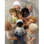 A box of 9 vintage vinyl dolls.