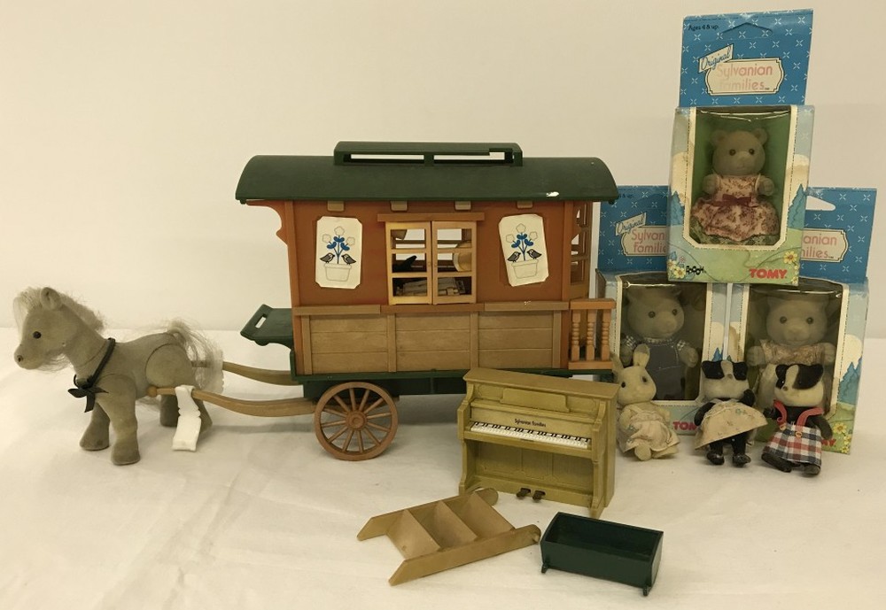 An unboxed Sylvanian Families Caravan together with 3 boxed figures.