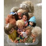 A box of vintage and modern vinyl dolls.