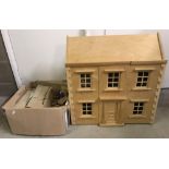 A vintage front opening wooden dolls house with removable roof.