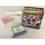 A boxed pink Nintendo DS Lite with Deluxe Accessories Pack & 1 game.