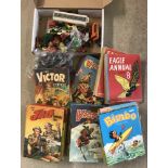 A box of assorted toys and annuals.