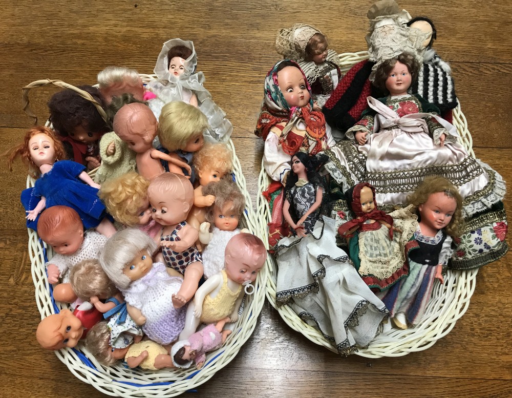 2 baskets of small vintage plastic and vinyl dolls.