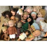 A box of small and medium vintage dolls.
