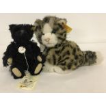 A miniature Steiff Black 1912 Teddy Bear together with a Steiff cat.