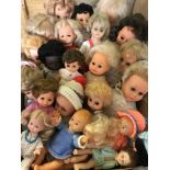 A box of mixed vintage vinyl dolls.