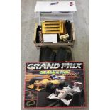 A Scalextric Grand Prix set with 2 cars, together with wooden grandstand, track and buildings.
