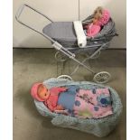 A modern dolls pram and raffia Moses basket together with 2 vinyl dolls.