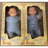 2 boxed Stork Club Baby boy dolls.
