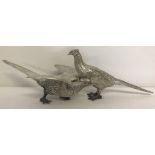 A pair of heavy pewter pheasant figures.