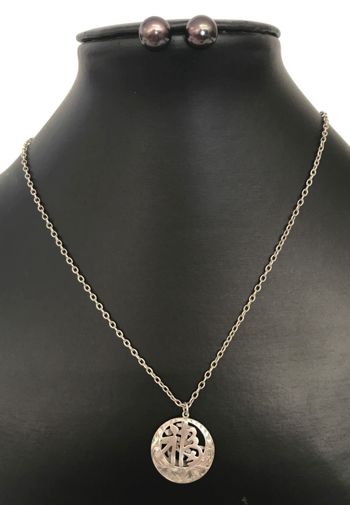 A white metal Chinese symbol pendant on a 25 inch sterling silver trace chain.