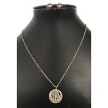 A white metal Chinese symbol pendant on a 25 inch sterling silver trace chain.