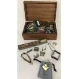 A quantity of costume and silver jewellery in a wooden jewellery box.