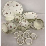 A vintage tea set with rose decoration.