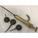 A vintage brass hand pump together with 3 small oil cans, one marked Singer.