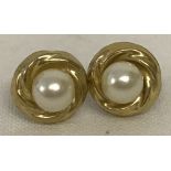 A pair of 9ct gold stud earrings set with faux pearls.