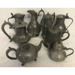 A collection of 8 antique pewter teapots, coffee pots and lidded urns.